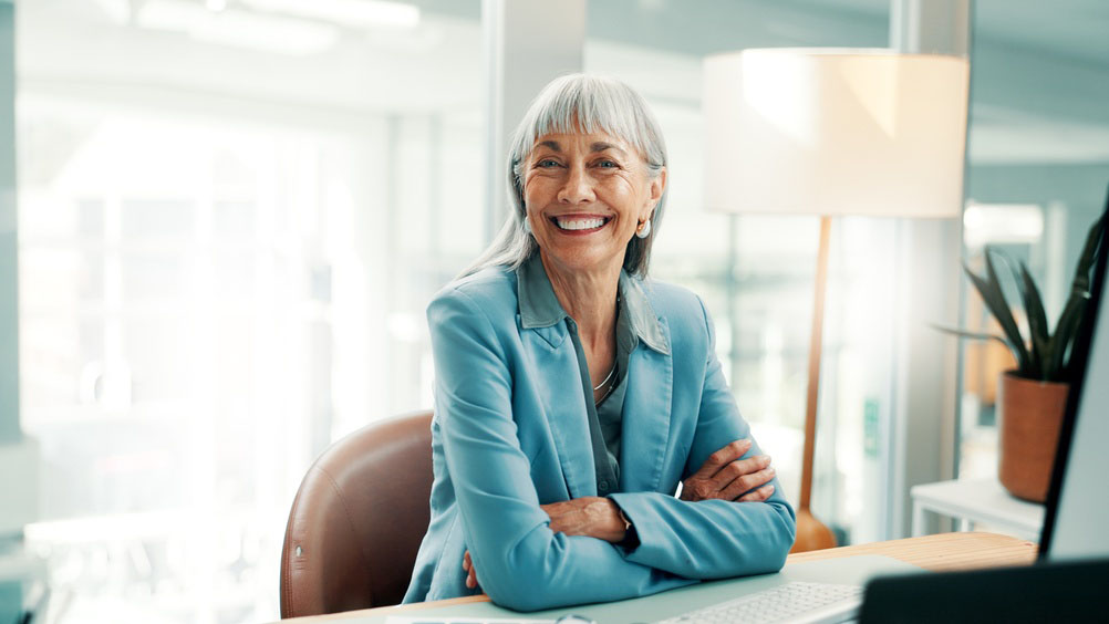 patient smiling after receiving offers on cosmetic and restorative dental care