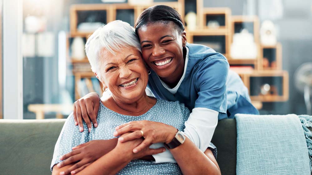 patient smiling with caregiver after compassionate dental implants