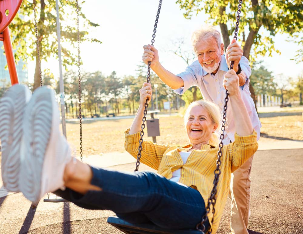 couple enjoying active lifestyle with healthy smiles after Dentures and Partials
