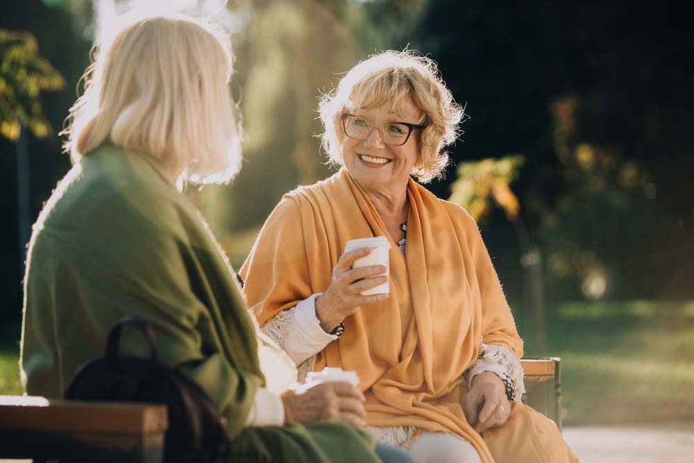 women enjoying conversation with healthy confident smiles after Dentures and Partials