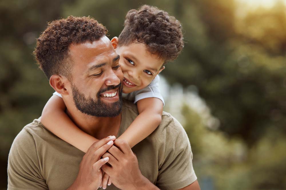 Father and son smiling with healthy bright smiles and teeth after Emergency Dentistry