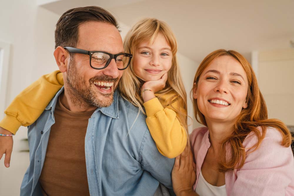 Family enjoying healthy smiles after visiting New You Dental Center for General Dentistry