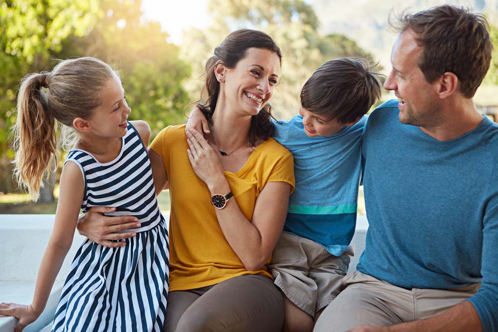 Family enjoying time together with healthy smiles after General Dentistry care