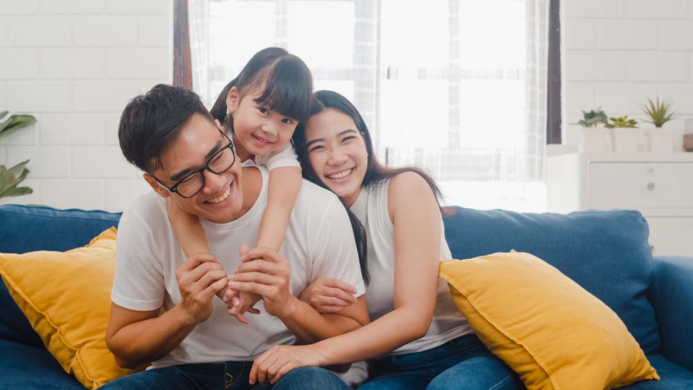 Happy family smiling together after family dental care appointment for IV Sedation in Livonia, MI