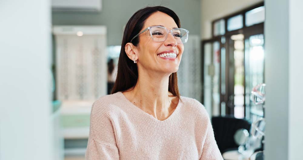 Professional woman smiling confidently after Zoom Whitening in Flint, MI