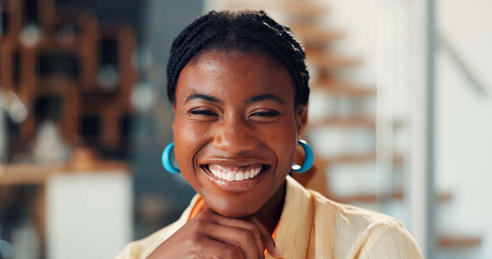 Young woman smiling confidently with healthy teeth and bright smile after Zoom Whitening
