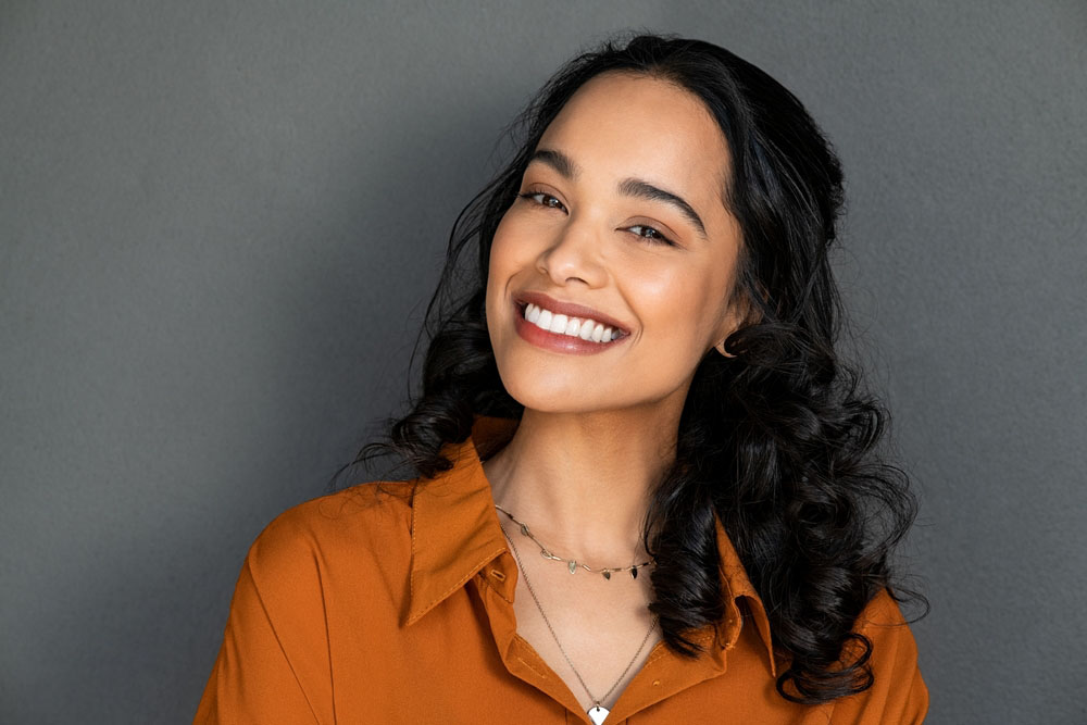 Young woman showing bright healthy smile after Zoom Whitening