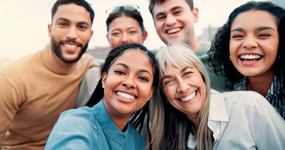 Group of friends smiling confidently after Wisdom Tooth Extraction