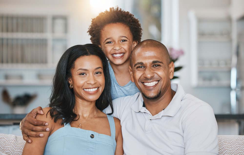 Family smiling together after Wisdom Tooth Extraction