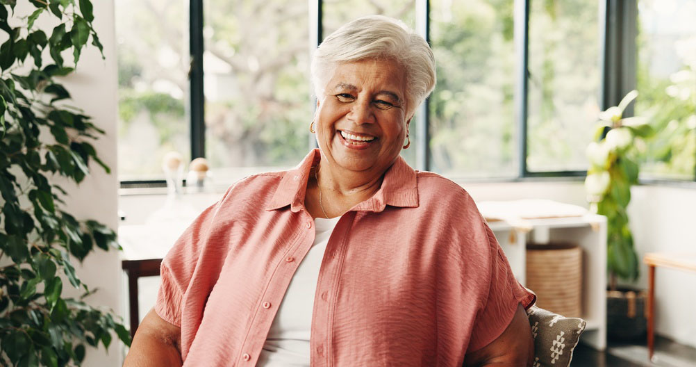 woman smiling after receiving compassionate family dental care for dental Dentures