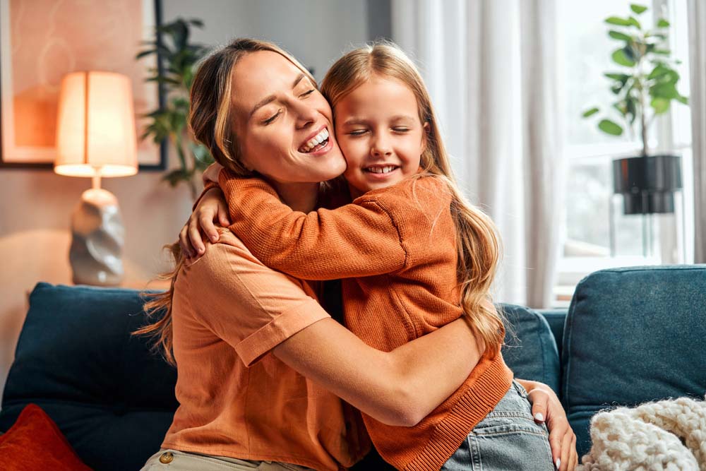 Mother and daughter smiling together with healthy happy smiles after Dental Emergencies