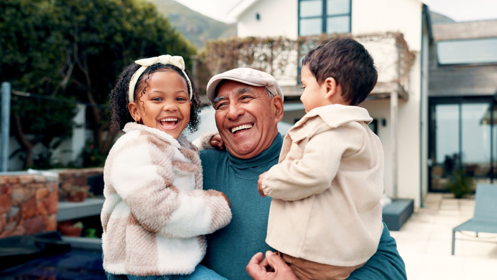 Grandfather and grandchildren smiling with healthy happy smiles
