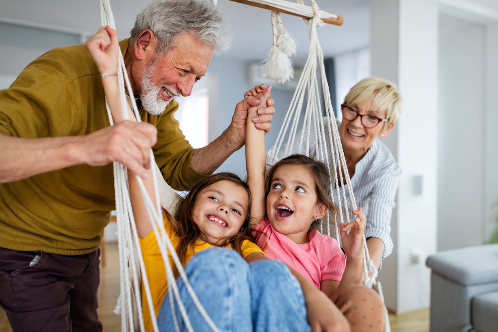 Happy grandparents and children smiling with healthy family smiles