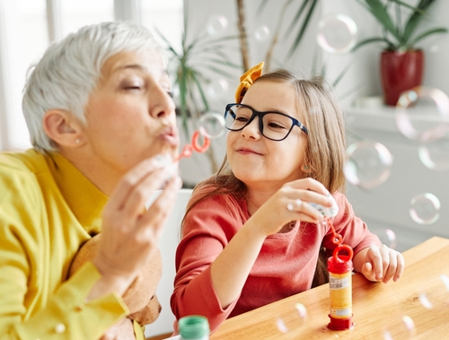 Grandmother and granddaughter sharing happy smiles and healthy teeth