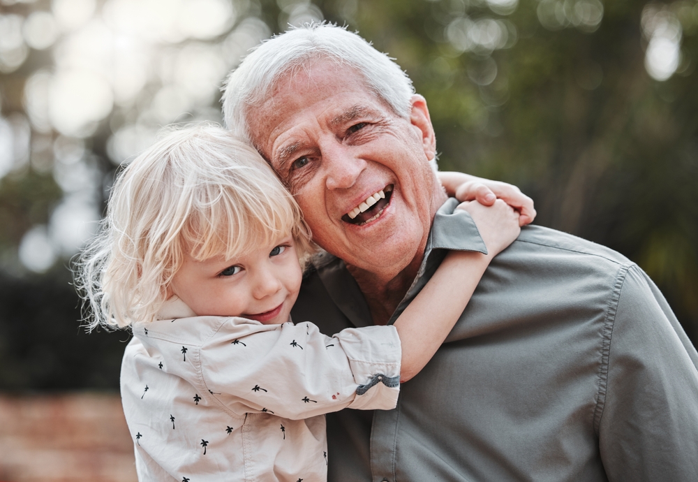 Grandfather and grandchild smiling with healthy happy smiles