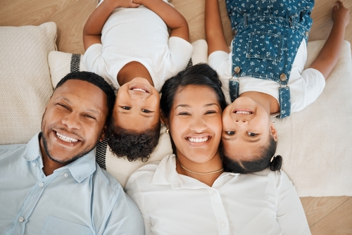 Happy family smiling with healthy teeth after family dental care