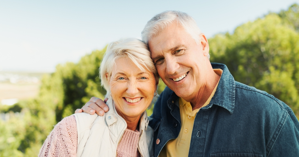 Happy couple smiling with healthy teeth after dental treatment