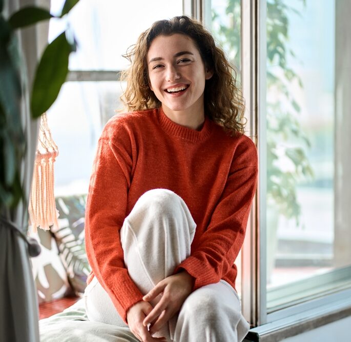 Young woman smiling confidently with healthy teeth and bright smile in Flint MI