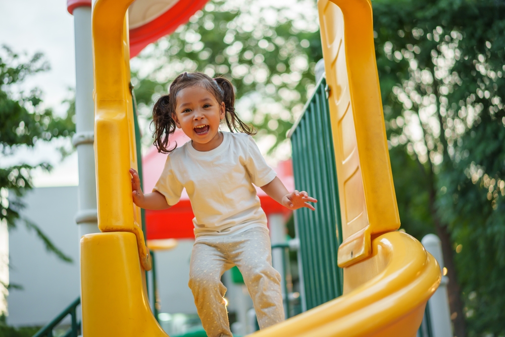 Child playing happily with healthy smile after pediatric dental visit