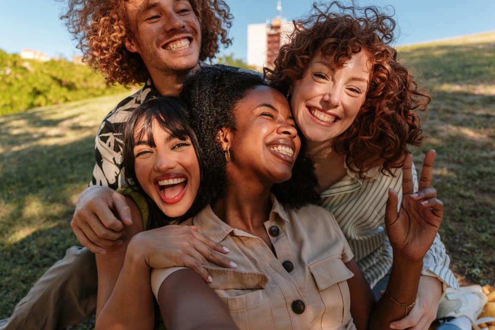 Group of friends smiling with bright healthy smiles after dental care
