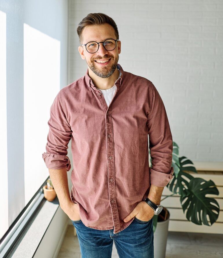 Man smiling confidently with healthy teeth after cosmetic dentistry in Auburn Hills, MI