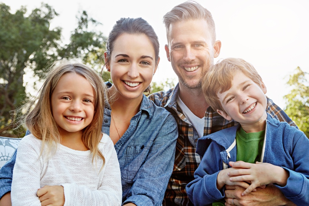 Smiling family enjoying healthy smiles and family dental care and services