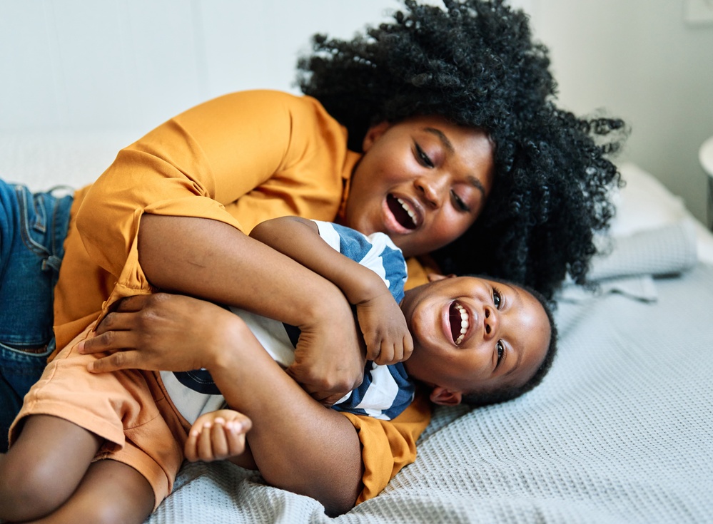 Mother and child laughing together with healthy happy smiles in Livonia MI