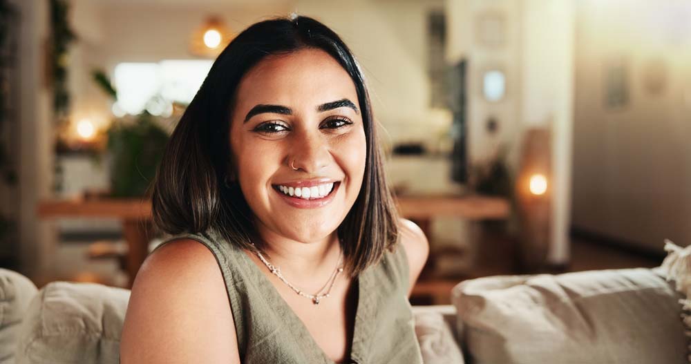 Woman smiling comfortably with beautiful smile after Wisdom Tooth Extraction